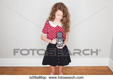 Girl holding old camera View Large Photo Image Stock Image - Girl holding old camera. Fotosearch