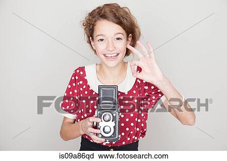 Girl holding old camera View Large Photo Image Stock Image - Girl holding old camera. Fotosearch