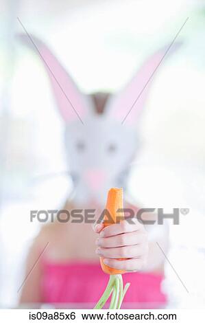 Girl in rabbit costume eating carrot View Large Photo Image Stock Photograph - Girl in rabbit costume eating carrot. Fotosearch