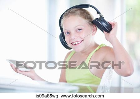 Girl listening to music on a smartphone View Large Photo Image Stock Image - Girl listening to music on a smartphone. Fotosearch