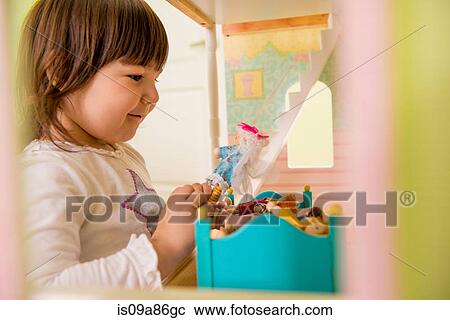 Girl playing with doll house View Large Photo Image Stock Image - Girl playing with doll house. Fotosearch
