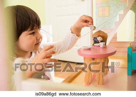 Girl playing with doll house View Large Photo Image Stock Image - Girl playing with doll house. Fotosearch