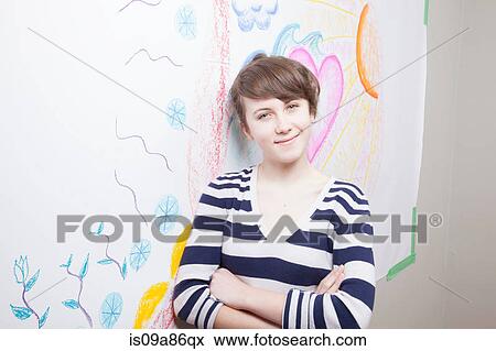 Stock Photo - Girl standing in front of mural. Fotosearch