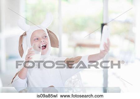Girl taking picture of herself drinking glass of milk View Large Photo Image Stock Image - Girl taking picture of herself drinking glass of milk. Fotosearch