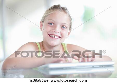 Stock Image - Girl using digital tablet. Fotosearch