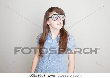 Girl wearing fake glasses grimacing View Large Photo Image Stock Photo - Girl wearing fake glasses grimacing. Fotosearch