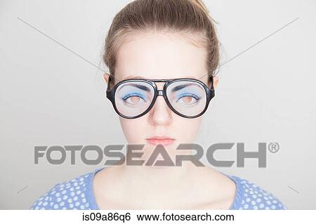 Stock Photograph - Girl wearing fake glasses. Fotosearch