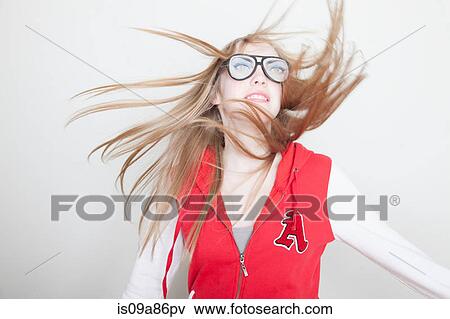 Stock Photo - Girl wearing fake glasses swinging hair. Fotosearch
