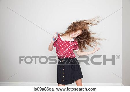 Girl wearing headphones, dancing and holding mp3 player View Large Photo Image Stock Image - Girl wearing headphones, dancing and holding mp3 player. Fotosearch
