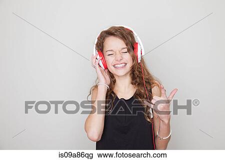 Girl wearing headphones with eyes closed View Large Photo Image Stock Image - Girl wearing headphones with eyes closed. Fotosearch