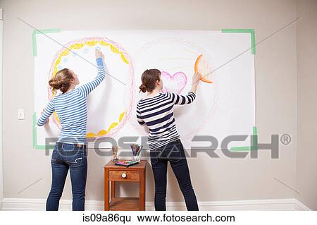 Girls drawing on wall View Large Photo Image Stock Photograph - Girls drawing on wall. Fotosearch