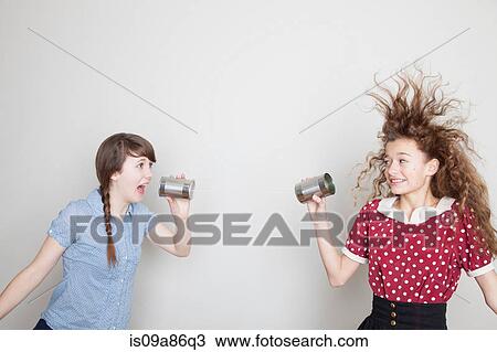 Girls using tin can telephones View Large Photo Image Stock Image - Girls using tin can telephones. Fotosearch