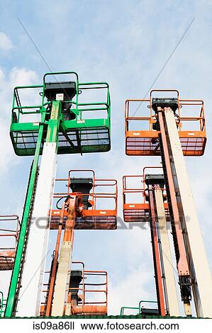 Low angle view of cherry pickers View Large Photo Image Stock Image - Low angle view of cherry pickers. Fotosearch
