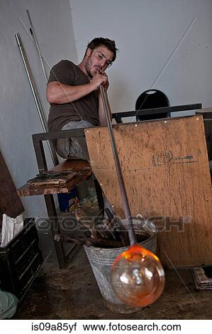 Man blowing glass View Large Photo Image Stock Image - Man blowing glass. Fotosearch