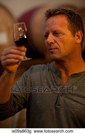Man checking the color of red wine View Large Photo Image Stock Image - Man checking the color of red wine. Fotosearch