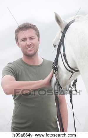Man with horse on beach View Large Photo Image Stock Photo - Man with horse on beach. Fotosearch