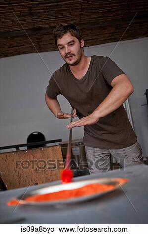 Picture - Man working in glass factory. Fotosearch