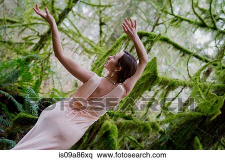 Stock Photography - Mature woman dancing in forest. Fotosearch
