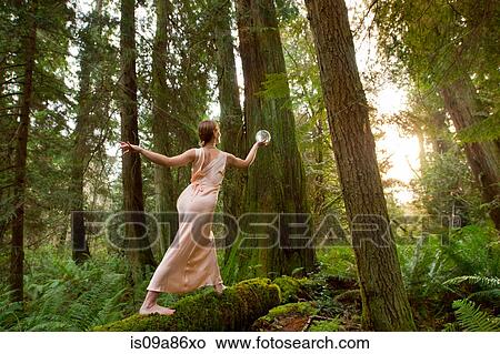 Mature woman standing on log in forest View Large Photo Image Picture - Mature woman standing on log in forest. Fotosearch
