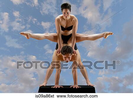 Mid adult dancers balancing on top of each other against blue sky View Large Photo Image Stock Photograph - Mid adult dancers balancing on top of each other against blue sky. Fotosearch