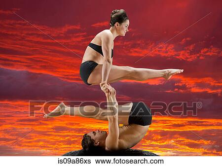 Mid adult dancers performing together at sunset View Large Photo Image Stock Photograph - Mid adult dancers performing together at sunset. Fotosearch