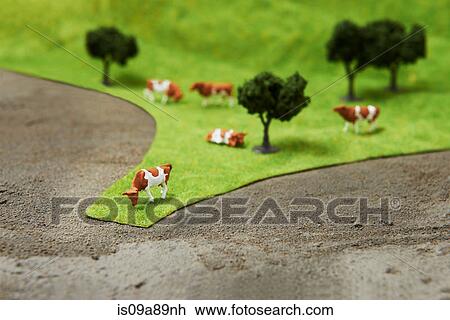 Model cows on pretend grass with trees View Large Photo Image Stock Image - Model cows on pretend grass with trees. Fotosearch