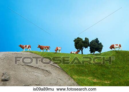Model cows on pretend grass with trees View Large Photo Image Stock Photograph - Model cows on pretend grass with trees. Fotosearch