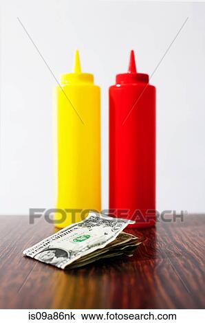 Money on table next to mustard and tomato sauce View Large Photo Image Stock Image - Money on table next to mustard and tomato sauce. Fotosearch