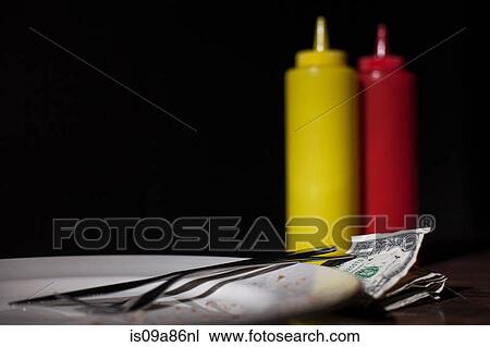 Money on table next to mustard and tomato sauce View Large Photo Image Stock Image - Money on table next to mustard and tomato sauce. Fotosearch