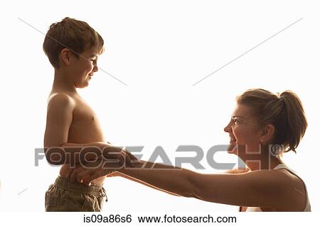 Mother and son smiling at eachother View Large Photo Image Stock Photograph - Mother and son smiling at eachother. Fotosearch