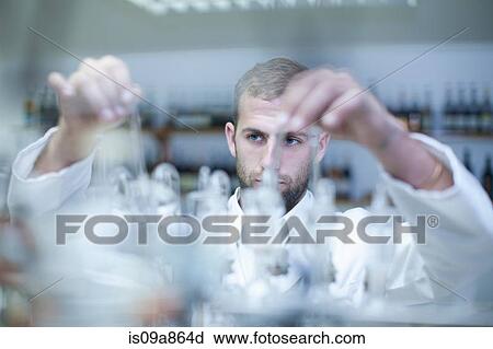 Oenologist mixing during sample testing in laboratory View Large Photo Image Stock Image - Oenologist mixing during sample testing in laboratory. Fotosearch