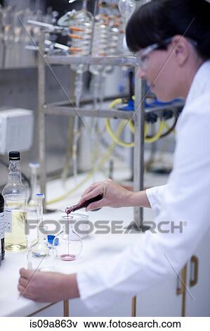Oenologist mixing during sample testing in laboratory View Large Photo Image Stock Photo - Oenologist mixing during sample testing in laboratory. Fotosearch