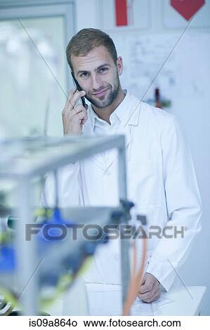 Oenologist on cellular phone View Large Photo Image Picture - Oenologist on cellular phone. Fotosearch