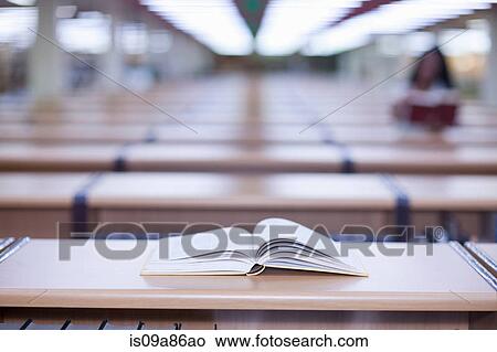 Open book on desk in library View Large Photo Image Picture - Open book on desk in library. Fotosearch