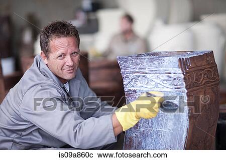 Painting and staining process in pottery factory View Large Photo Image Stock Image - Painting and staining process in pottery factory. Fotosearch