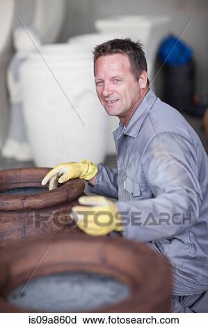 Painting and staining process in pottery factory View Large Photo Image Stock Image - Painting and staining process in pottery factory. Fotosearch