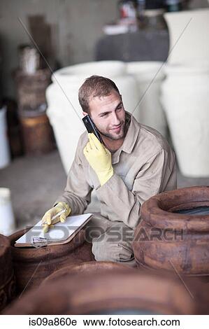 Painting and staining process in pottery factory View Large Photo Image Stock Image - Painting and staining process in pottery factory. Fotosearch