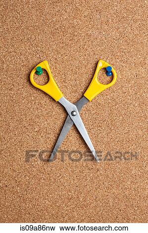 Stock Photo - Pair of scissors on cork board. Fotosearch