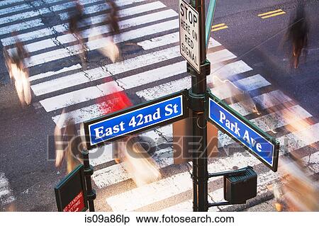Stock Photography - Park Avenue street sign and blurred pedestrians crossing road New York City, USA. Fotosearch