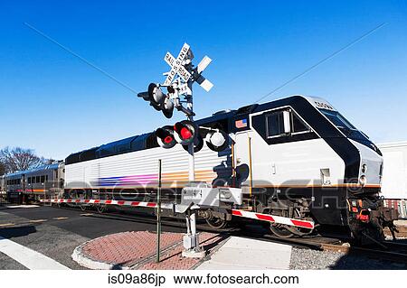 Passenger train passing level crossing View Large Photo Image Stock Photography - Passenger train passing level crossing. Fotosearch