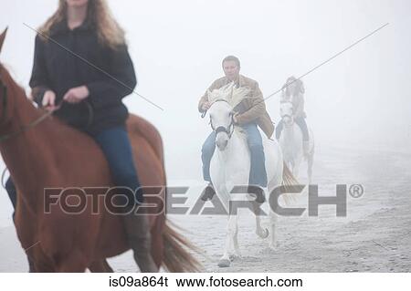 People riding horse on beach View Large Photo Image Stock Photograph - People riding horse on beach. Fotosearch