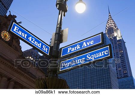 Stock Image - Pershing Square and Park Avenue street signs at dusk, New York City, USA. Fotosearch