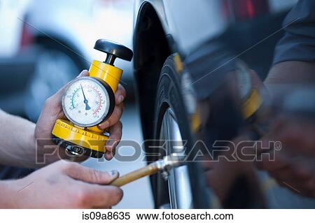 Stock Photography - Person using pressure gauge. Fotosearch