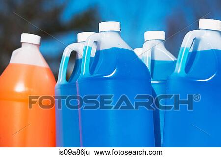 Plastic containers of orange and blue liquid View Large Photo Image Stock Photograph - Plastic containers of orange and blue liquid. Fotosearch