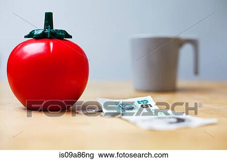 Plastic tomato sauce dispenser next to money and a cup View Large Photo Image Stock Image - Plastic tomato sauce dispenser next to money and a cup. Fotosearch