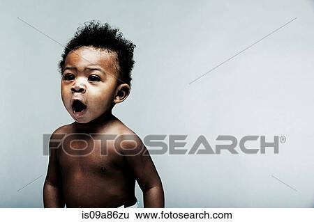 Stock Photograph - Portrait of baby boy looking away. Fotosearch