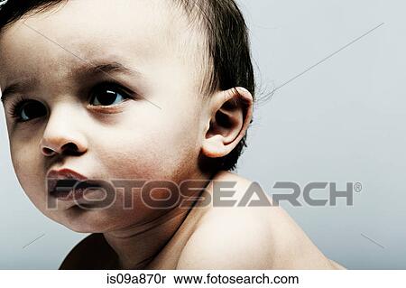 Stock Photography - Portrait of baby boy looking away. Fotosearch
