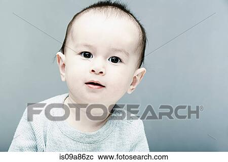 Portrait of baby boy wearing grey top View Large Photo Image Stock Image - Portrait of baby boy wearing grey top. Fotosearch