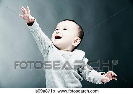 Stock Image - Portrait of baby boy wearing grey top. Fotosearch