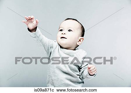 Stock Image - Portrait of baby boy wearing grey top. Fotosearch